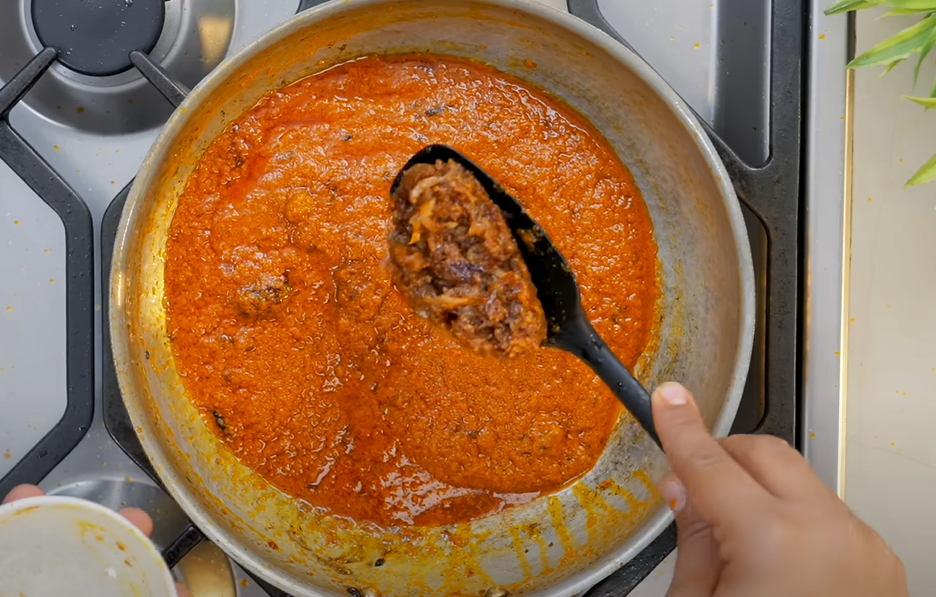 Tomato-onion masala base being cooked for paneer curry