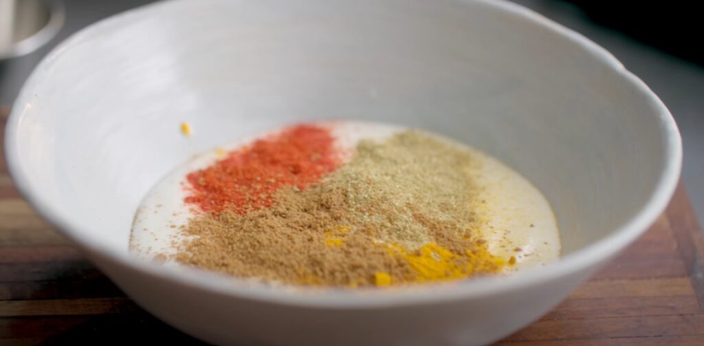 Mixing curd and spices for Shahi Paneer gravy