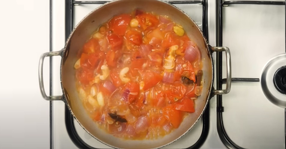 Cooking spices and onion in a pan for Shahi Paneer gravy